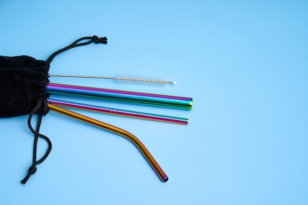 Environmental trend reusable metal beverage straws kit with cleaning tool in transportation bag.