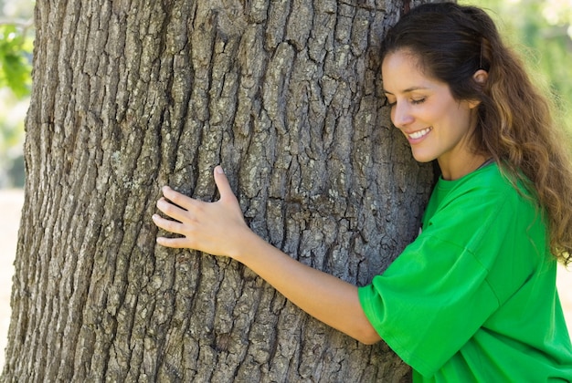 Environmentalist hugging tree trunk 