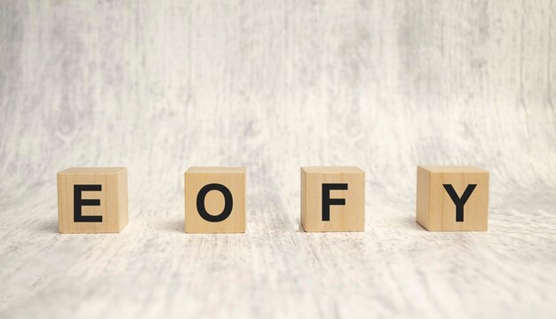 EOFY End of Financial Year text wood cubes and white background