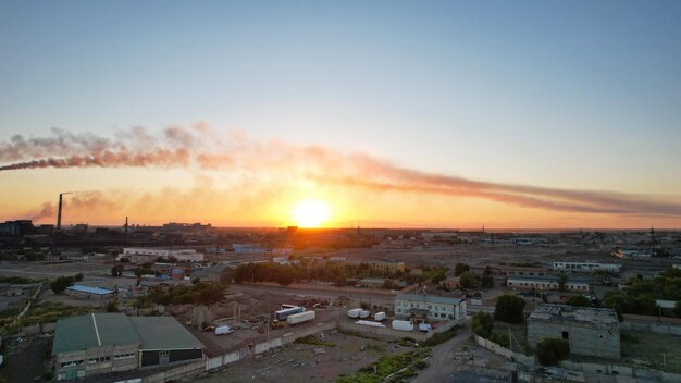 An epic sunset with a view of the smoke of factory