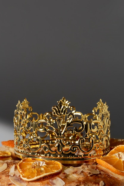 Epiphany day dessert close-up with crown and dried citrus