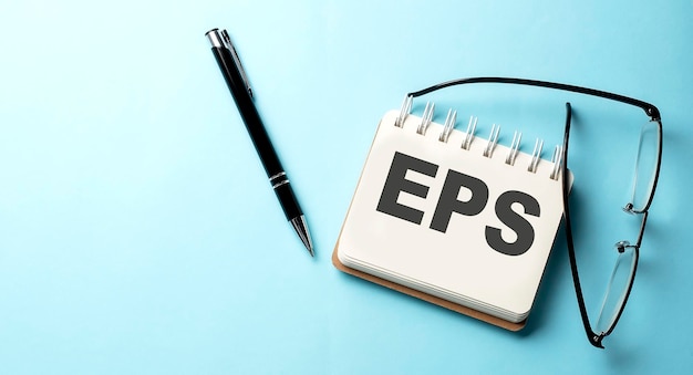 EPS text written on a notepad on the blue background