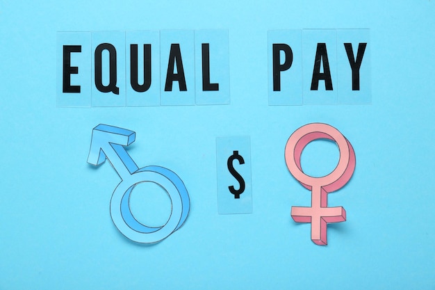 Equal pay concept Gender symbols on light blue background flat lay