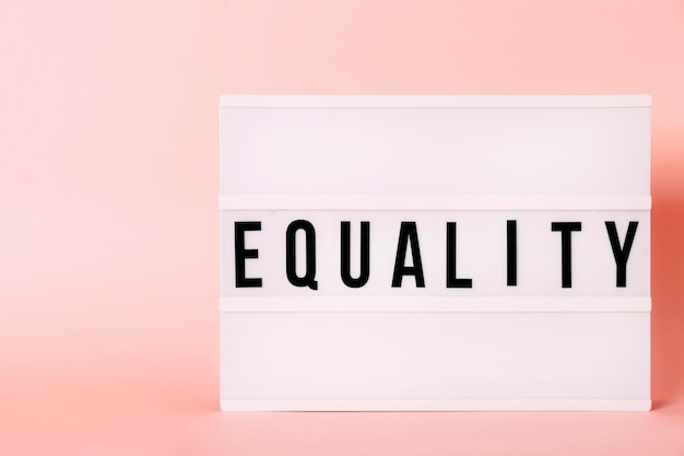 "Equality" Luminous poster with copy space. Feminist themed letters with pink background. Feminism concept. Message concept