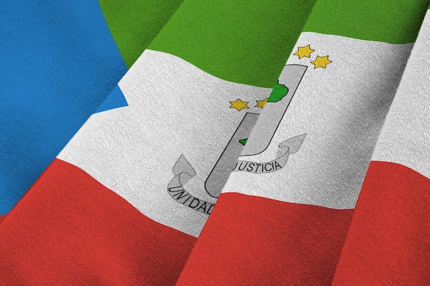 Equatorial Guinea flag with big folds waving close up under the studio light indoors The official symbols and colors in banner