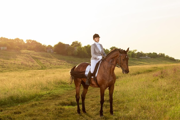 Equestrian sport. Young woman riding horse on dressage advanced test