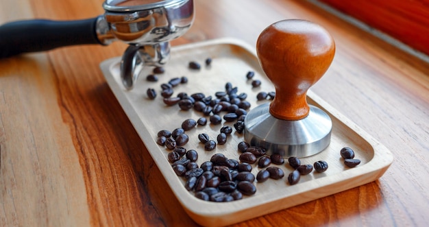 Equipment of barista coffee tool tamper and tempered coffee in portafilter roasted coffee beans