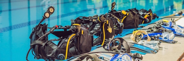 Equipment for diving is on the edge of the pool, ready for a lesson BANNER, long format