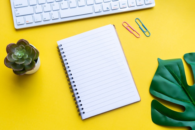 Equipment and empty notebook with on yellow