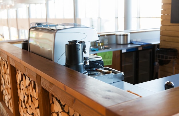 equipment, object and technology concept - close up of coffee machine at bar or restaurant counter