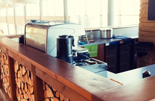 Photo equipment, object and technology concept - close up of coffee machine at bar or restaurant counter