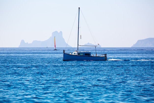 Es Vedra Ibiza silhouette with boats Formentera view