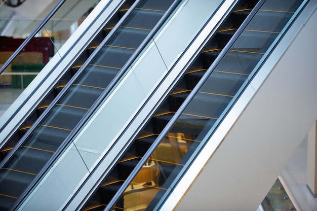 Escalator and empty modern shopping mall interior