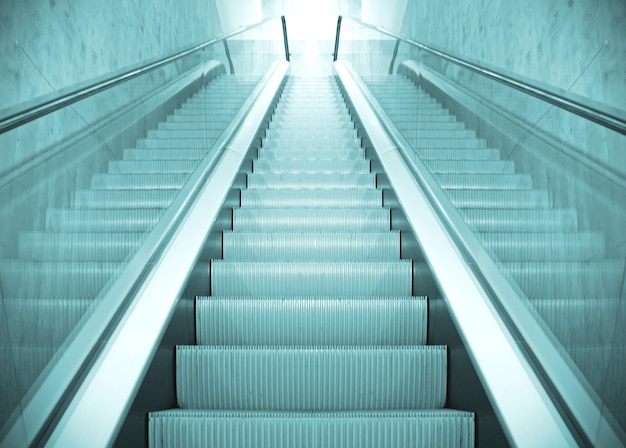 An escalator with the light shining through it