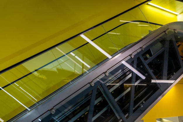 Escalators on a yellow background in a museum