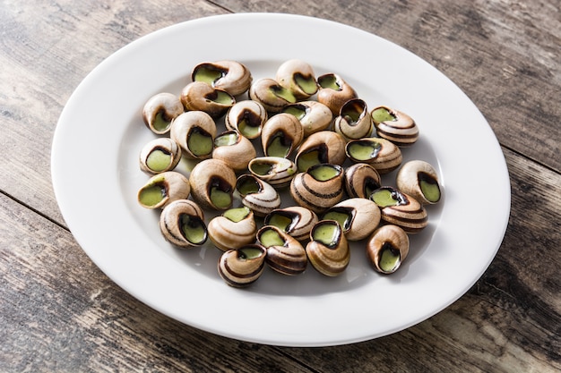 나무 테이블에 Escargots 드 부르고뉴입니다.