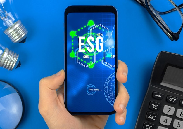 ESG concept background. Environmental, social and governance in sustainable and ethical business. Modern smartphone on table. Ecology care photo