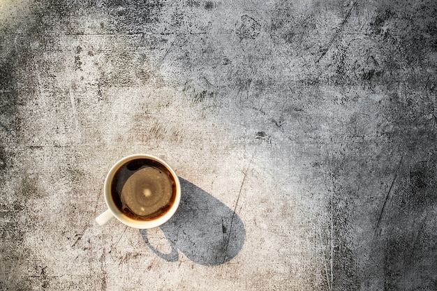 Espresso in a coffee ceramic cup on concrete grunge style texture background  Top view