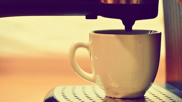 Photo espresso machine brewing a coffee.