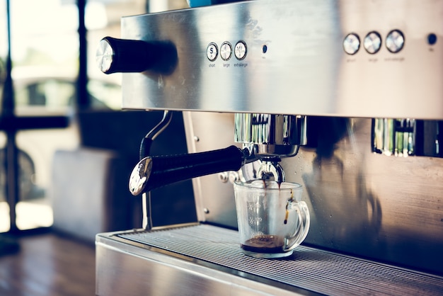 Photo espresso machine making coffee with blue cup in pub, bar, restaurant