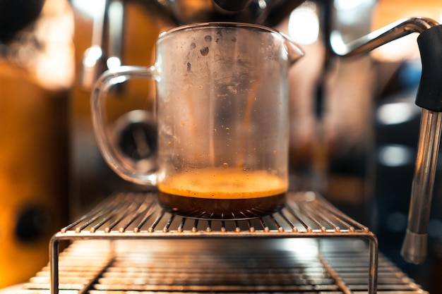 Espresso machine pouring coffee into glasscoffee machine preparation