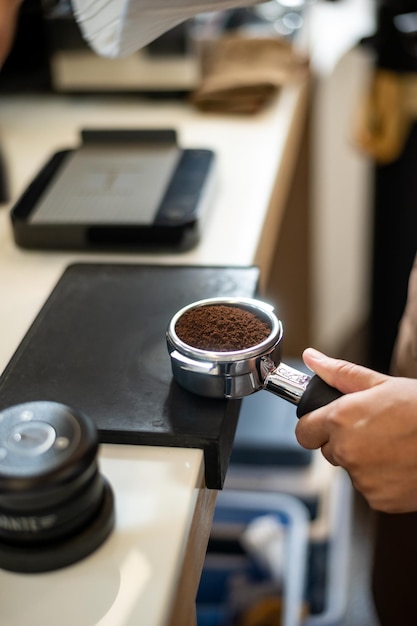 Photo espresso machine with ground coffee ready to make a drink