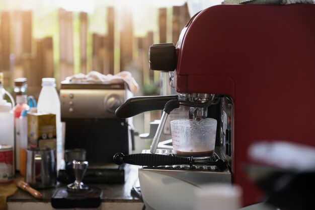 Espresso pouring from coffee machine. Professional coffee brewing.