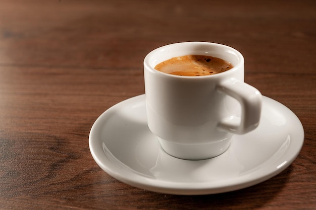 Espresso in a short glass on wooden background