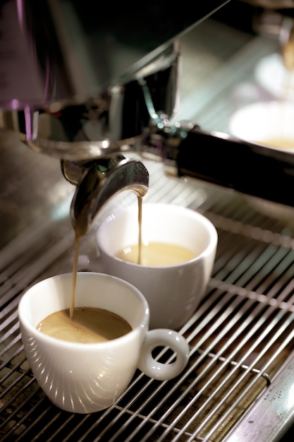 Espresso shot from coffee machine in coffee shop