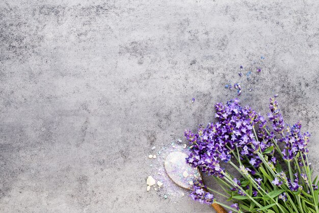 Essential lavender salt with flowers top view.