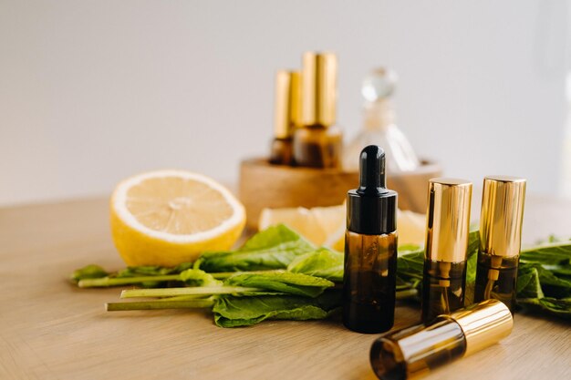 Essential oil in bottles with lemon and mint fragrance lying on a wooden surface