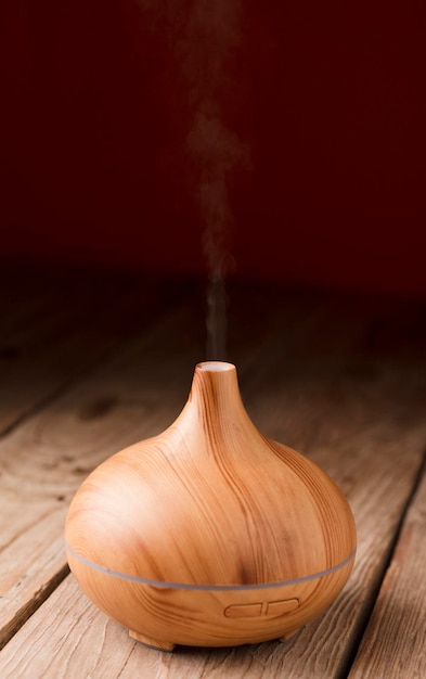 Essential oil diffuser wooden with graceful and smooth curves red background