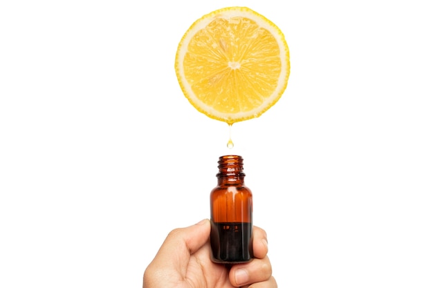 Essential oil drip from lemon on white background