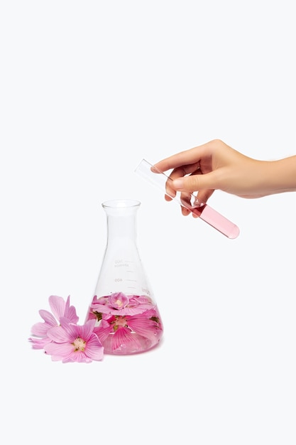 Essential oil in a glass bottle with flowers