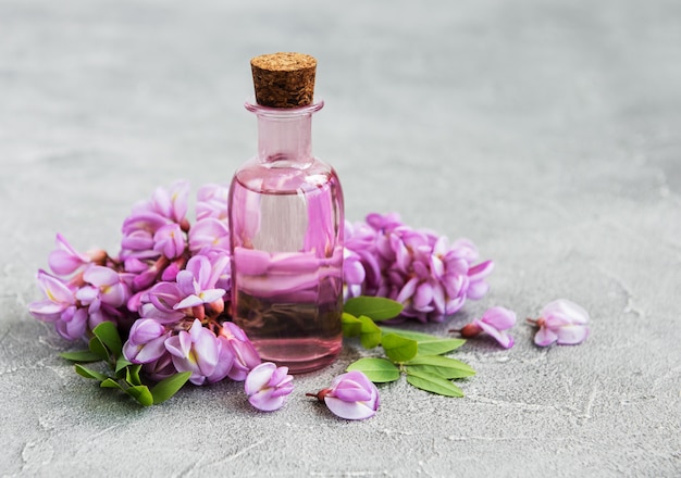 Essential oil and pink acacia flowers