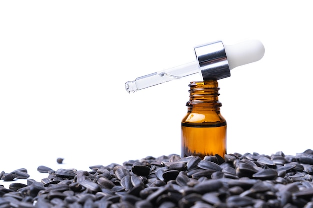 Essential oil sunflower seeds on a white background copy space