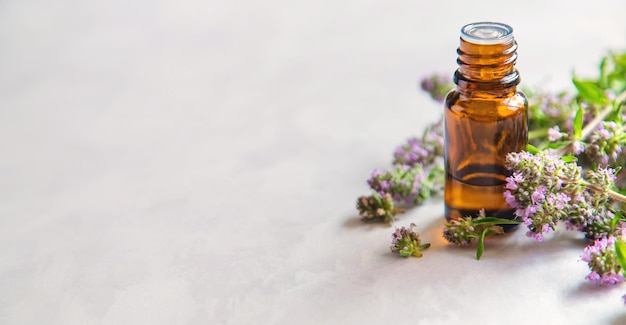 Essential oil of thyme in a bottle Selective focus