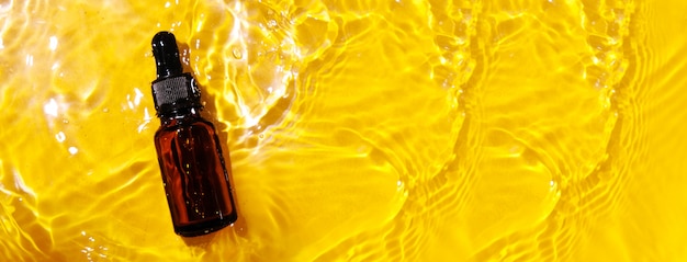 Essential oil in water on a yellow