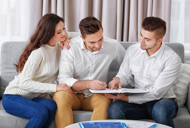 Foto incontro di agente immobiliare con coppia felice, sulla luce