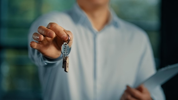 Estate agent salesman banker businessman show at camera bunch of keys from new house offer housing