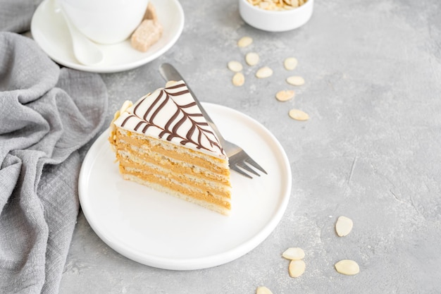 Esterhazy cake with almonds and pralines on a gray concrete background Selective focus Copy space