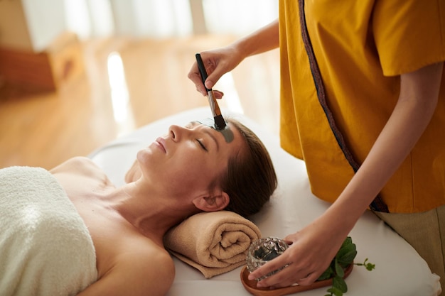 Esthetician Applying Detoxifying Mask