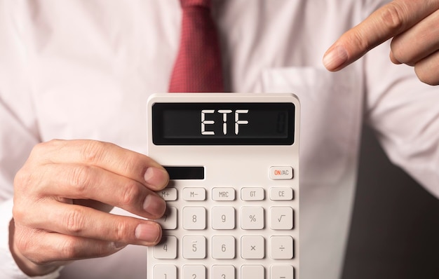 ETF analysis concept Word on calculator