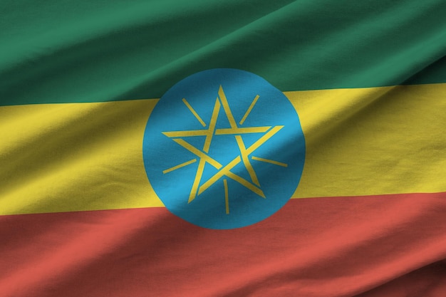 Ethiopia flag with big folds waving close up under the studio light indoors The official symbols and colors in banner