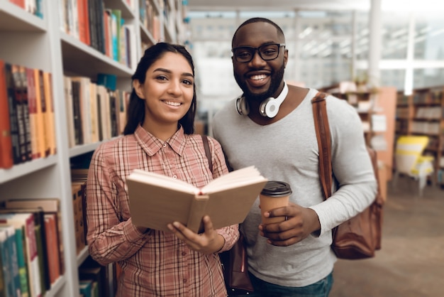 Ethnic indian mixed race girl and black guy in library