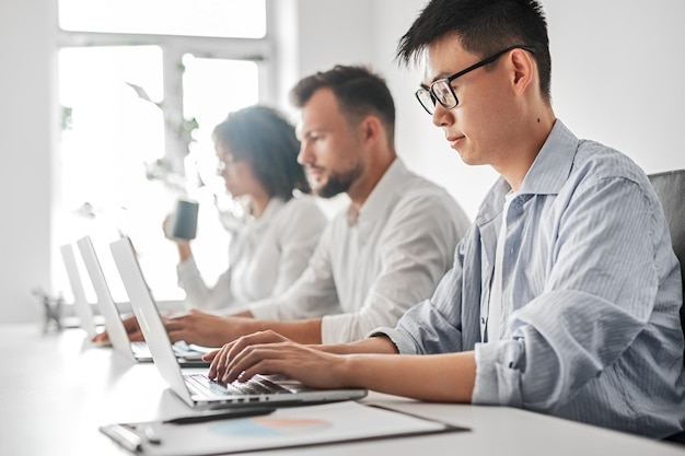 Ethnic man working on laptop in office