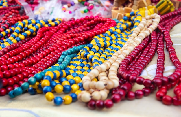 Ethnic wooden multicolored necklaces at market, traditional decorations