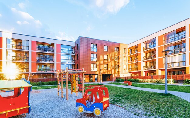 EU Apartment house and home buildings complex concept. Street with children playground. With sun light