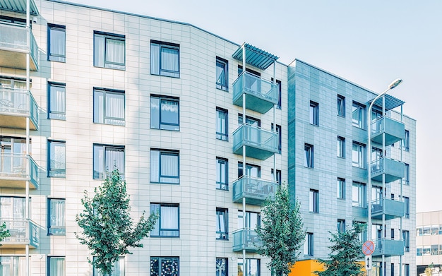 EU Trees near Complex of new apartment residential building with outdoor facilities.