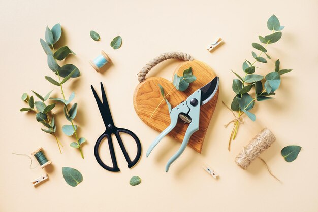 Eucalyptus bouquet creating with baby blue eucalyptus branches over pastel background Florist work concept Top view Flat lay